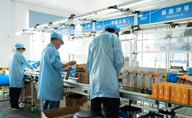 Workers on an assembly and packaging line inside the PCS factory